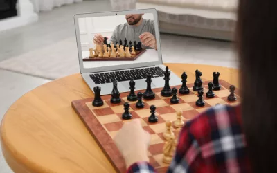 Woman having chess lesson with partner via online video on laptop